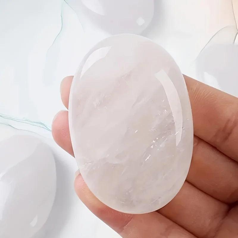 Smooth, oval white quartz natural crystal palm stone for stress relief and healing energy.