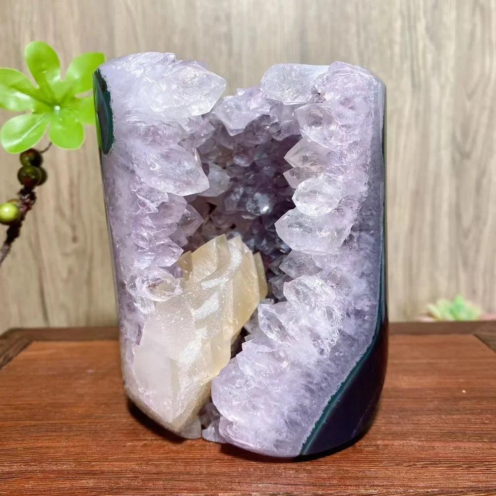 Natural amethyst geode with a central calcite crystal, a unique healing reiki stone for home decor and energy balancing.