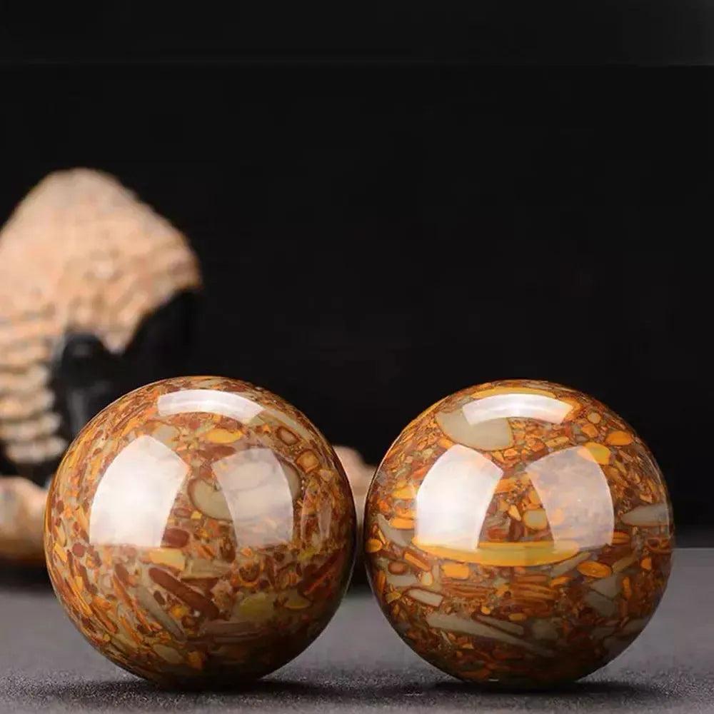 Polished Nuwa Stone Baoding Balls pair, showcasing earthy patterns and rich brown-orange coloration for stress relief.