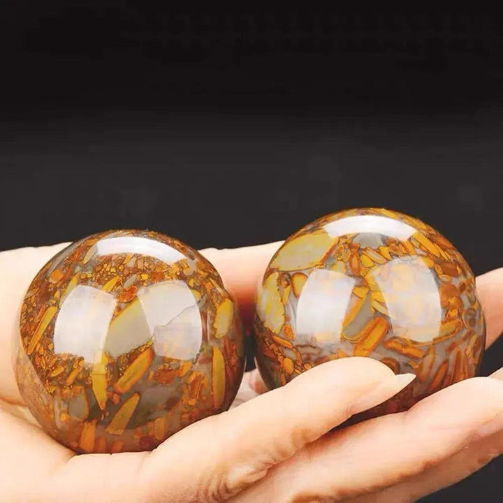 Polished Nuwa Stone Baoding Balls pair, showcasing earthy patterns, rich coloration, and smooth, cool surface for stress relief.