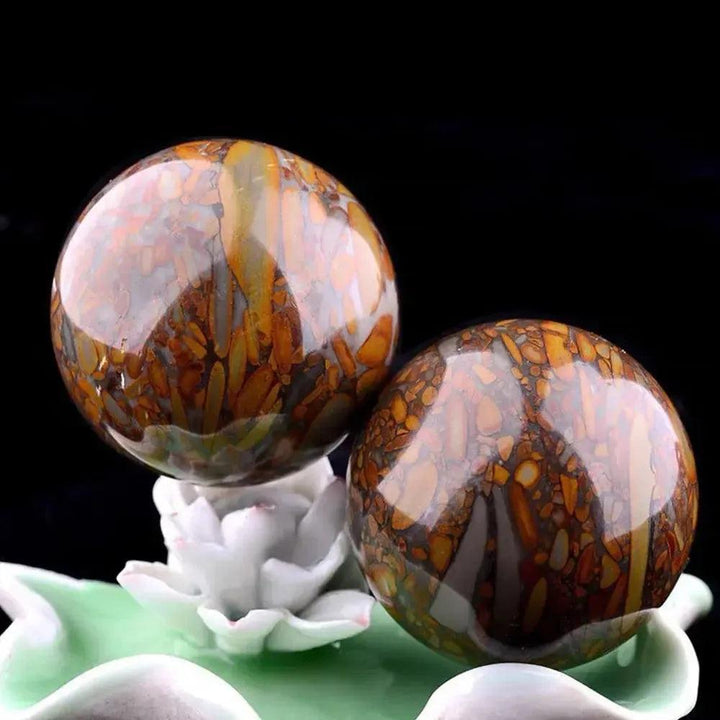 Polished Nuwa Stone Baoding Balls pair, showcasing earthy patterns and rich brown, orange, and gray hues for wellness.