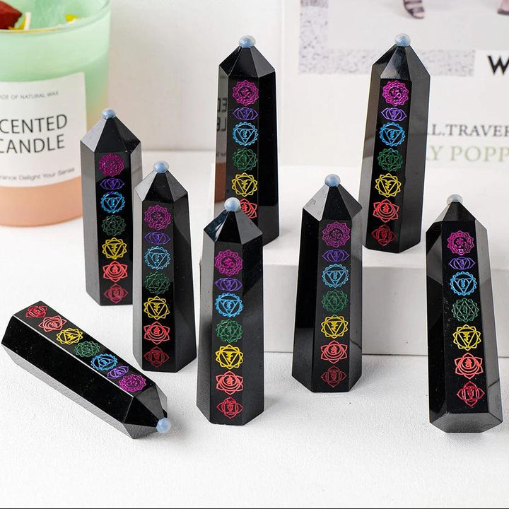Runyangshi black obsidian crystal tower with engraved colorful chakra symbols for energy healing and Feng Shui decor.