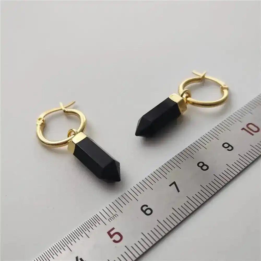 Crystal Destiny's black obsidian point dangle earrings with gold-plated hoops, shown with a ruler for size.