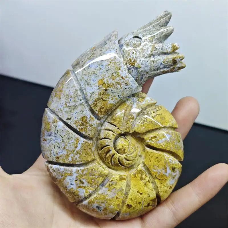 Polished Ocean Jasper snail conch sculpture featuring vibrant yellow and green orb patterns for healing and prosperity.