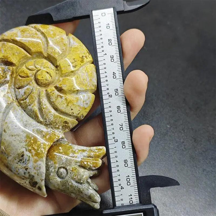 Polished Ocean Jasper snail sculpture with vibrant yellow and green orbs, measured by calipers for size and healing joy.