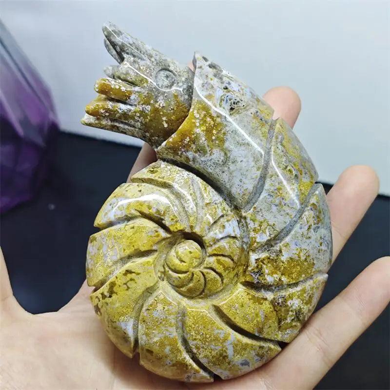 Polished Ocean Jasper snail conch sculpture featuring vibrant multicolor orb patterns for healing and abundance.