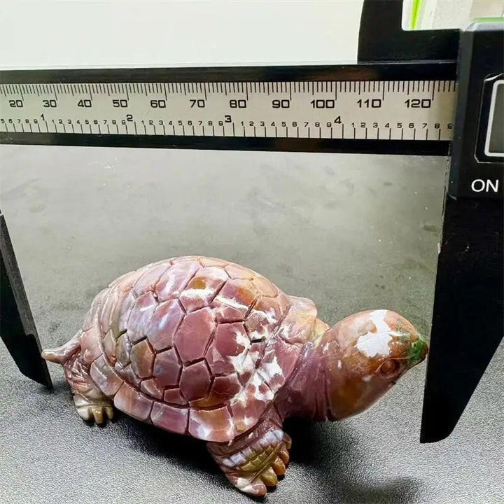 Hand-carved Ocean Jasper turtle with swirling cream, sage, rust, and seafoam colors, measured by a caliper.