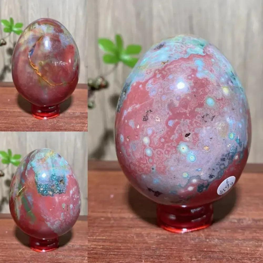 Ocean Jasper crystal egg from Crystal Destiny, featuring red, green, and blue hues with unique orb patterns.