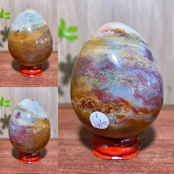 Ocean Jasper crystal egg from Crystal Destiny, featuring greens, pinks, yellows, and browns on a red stand.