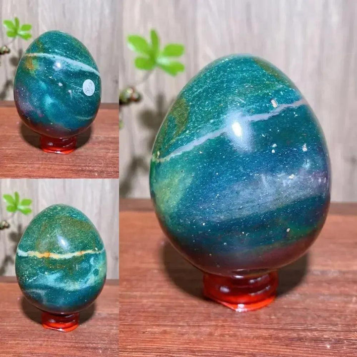 Crystal Destiny's polished Ocean Jasper egg, showcasing vibrant green, blue, and white patterns on a red stand.