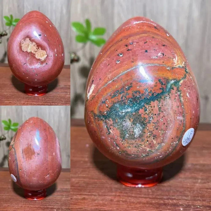 Polished red Ocean Jasper crystal egg with green, brown, and cream patterns, radiating peaceful energy from Crystal Destiny.
