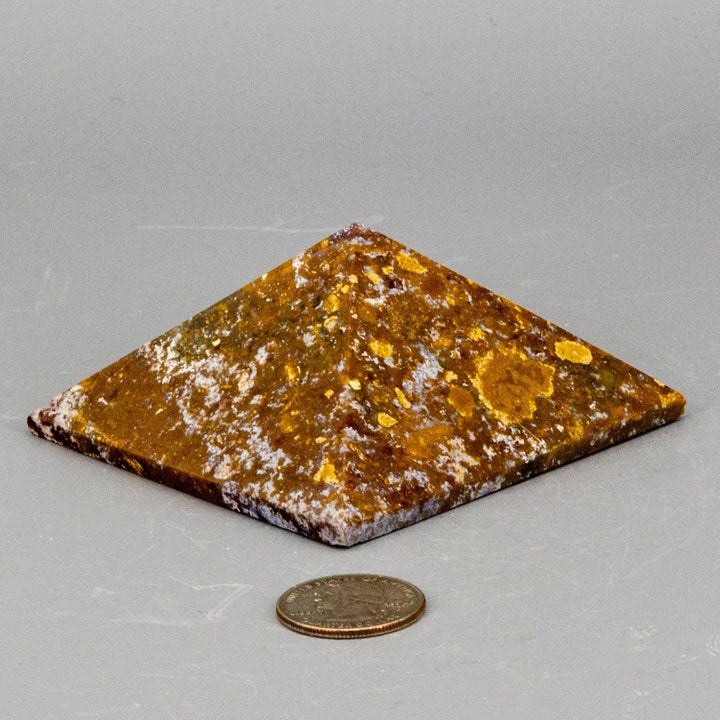 Polished Ocean Jasper Crystal Pyramid, 82.55mm, with earthy tones, orbicular patterns, and a quarter for scale.