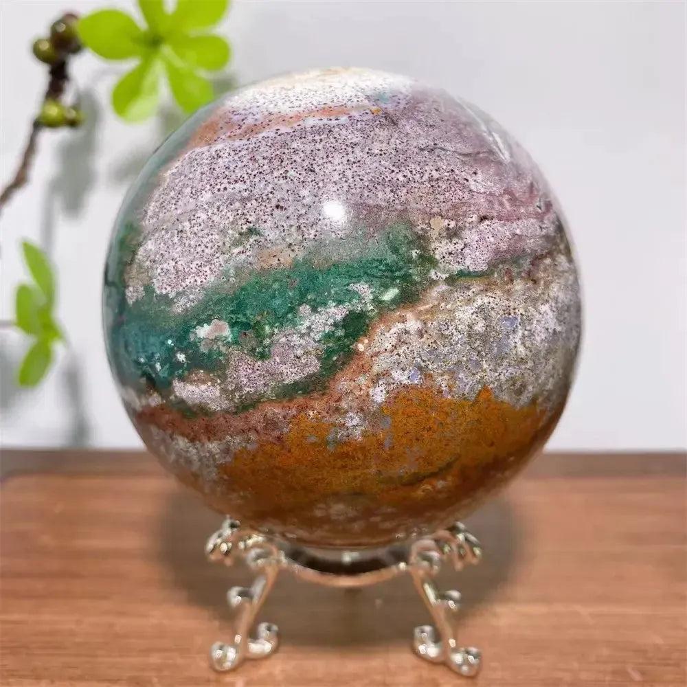 Ocean Jasper Crystal Sphere by Crystal Destiny, featuring vibrant greens, pinks, creams, and earthy tones with orb patterns.