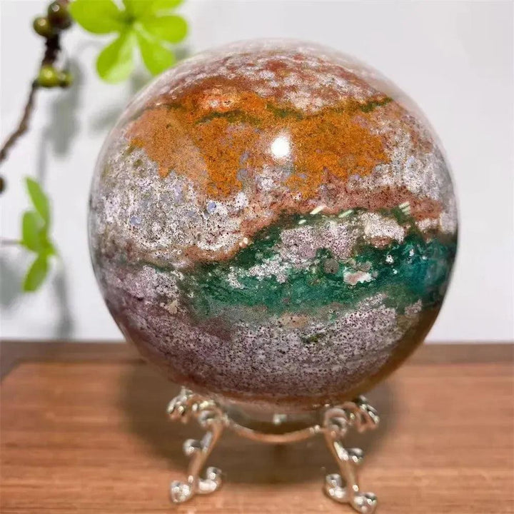Polished Ocean Jasper Crystal Sphere from Crystal Destiny, featuring green, pink, cream, and earthy swirling patterns.
