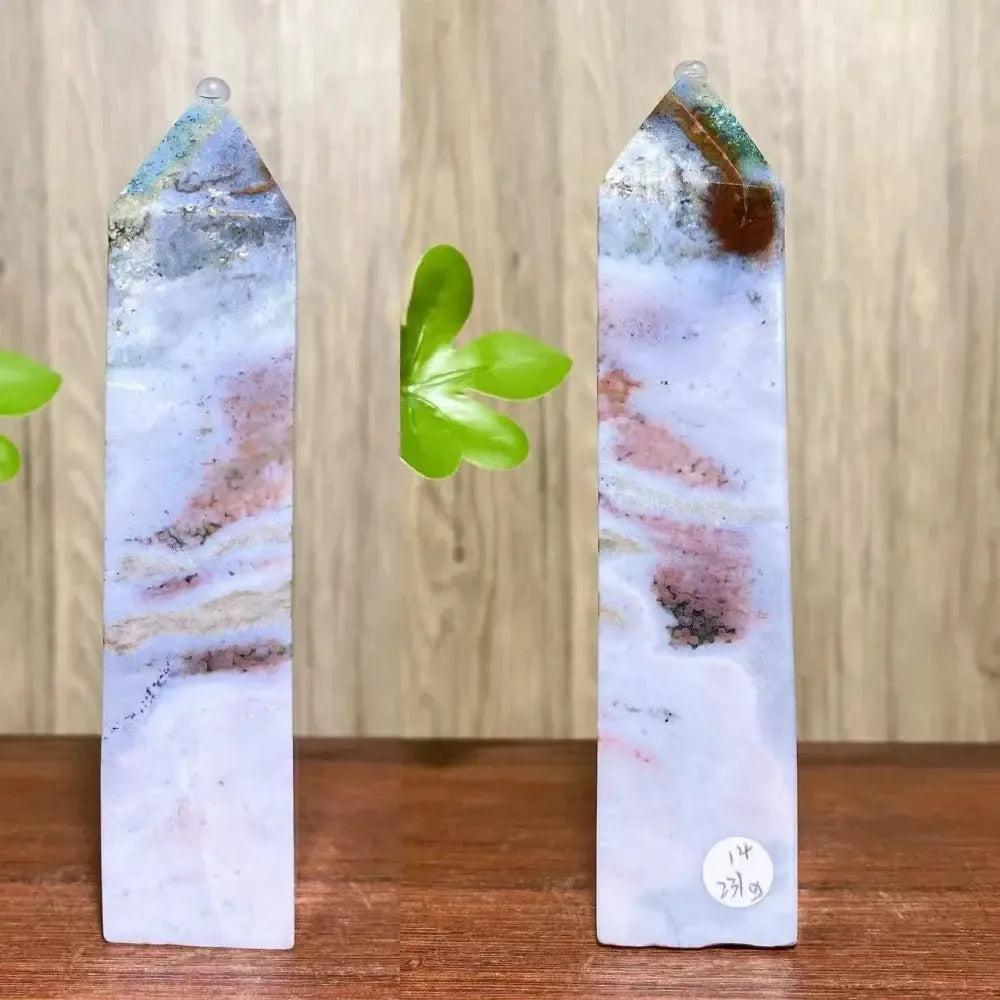Two tall, polished Ocean Jasper crystal towers from Crystal Destiny, displaying swirling blues, pinks, and earthy tones.