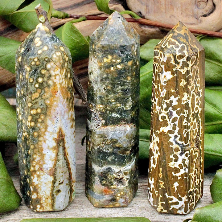 Three natural Ocean Jasper pillar crystals with unique green, brown, and white patterns for healing decor.