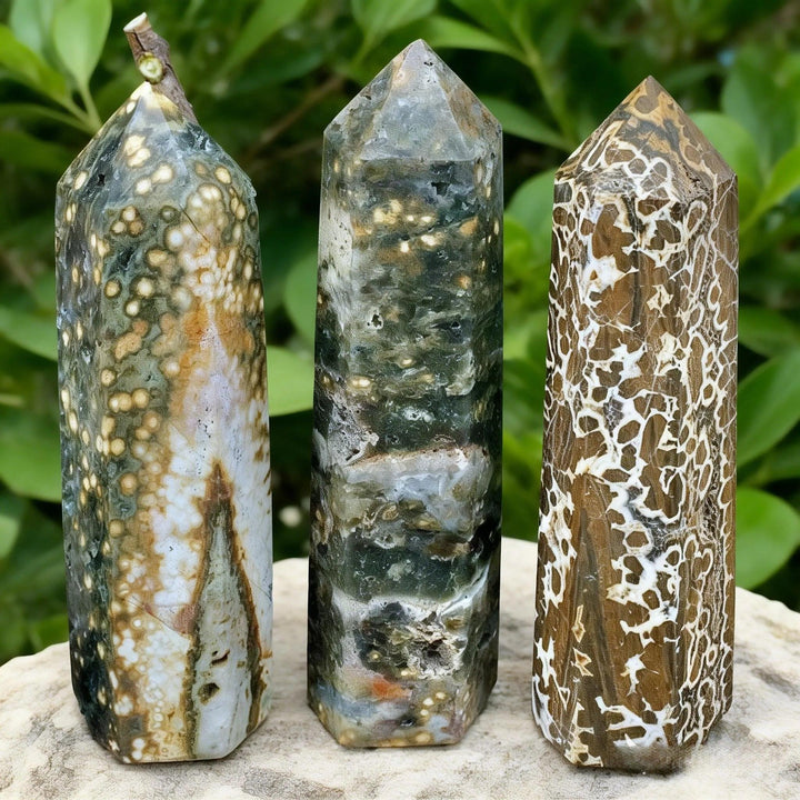 Three natural Ocean Jasper crystal pillars with unique green, brown, and white patterns for healing decor.