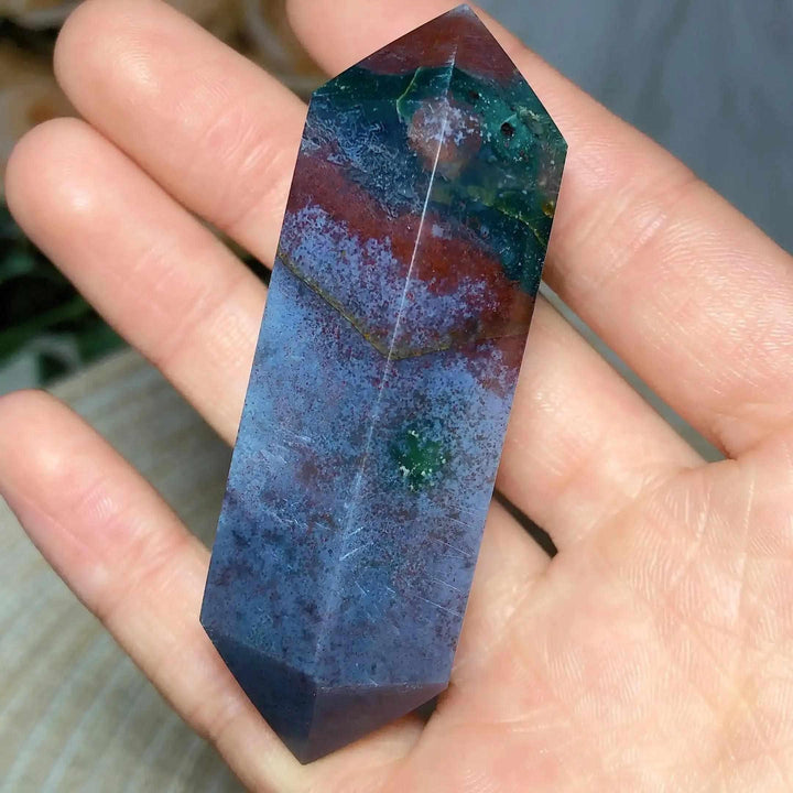 Polished Ocean Jasper double point tower featuring vibrant green, blue, and red orb patterns for heart chakra healing.