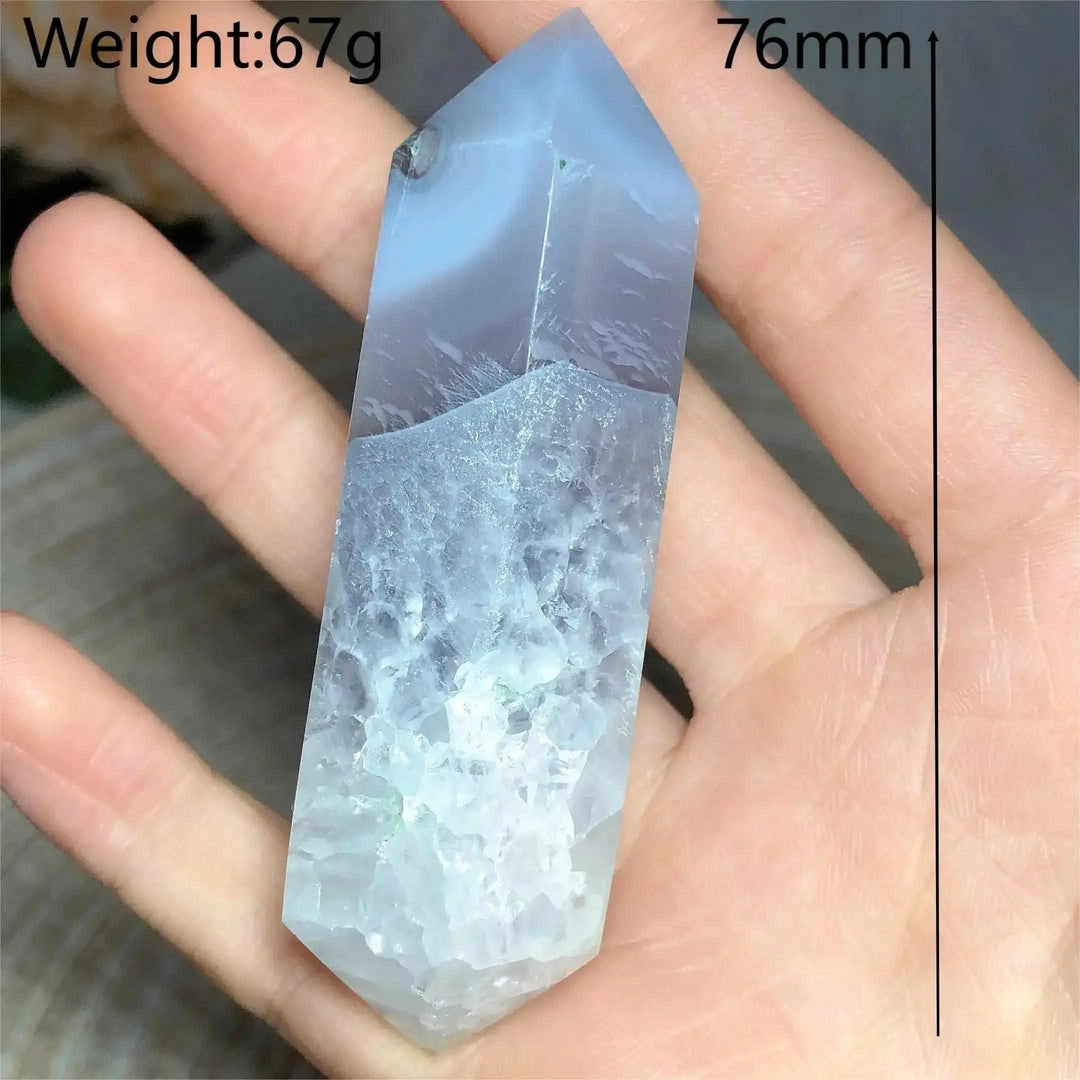 Polished 76mm Ocean Jasper double point tower with calming blue and white crystalline patterns held in a palm.