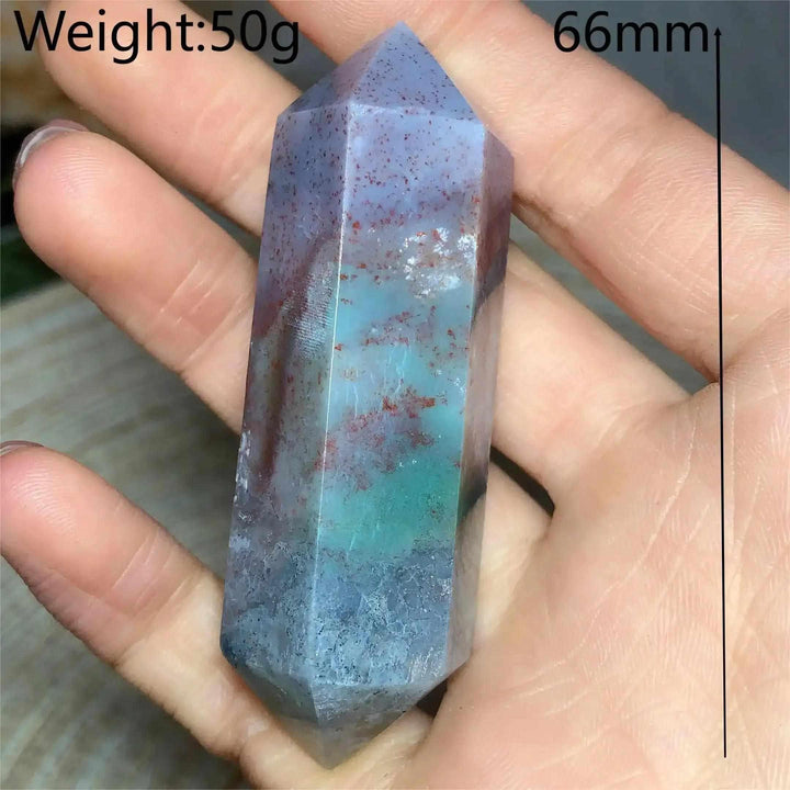 Polished Ocean Jasper double point tower with green, cream, and pink orb patterns held in a palm for heart chakra healing.