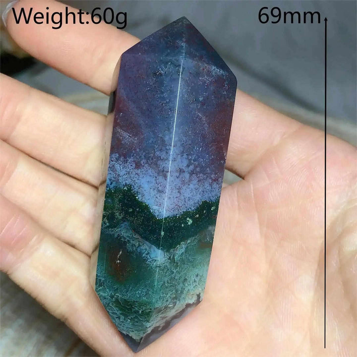 Polished Ocean Jasper double point tower featuring green and purple orb patterns, 69mm tall, held in a palm for healing.