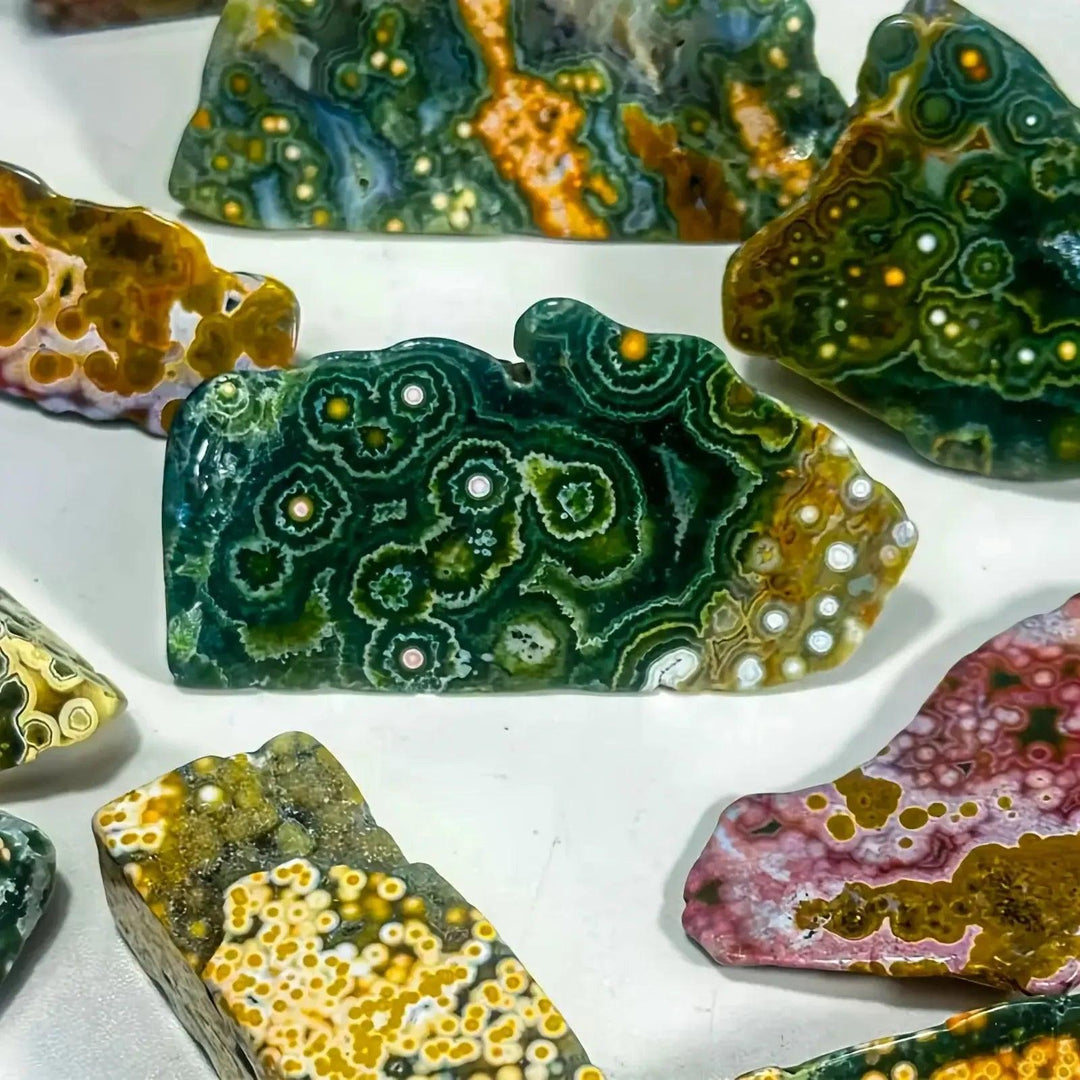 Multicolor Ocean Jasper freeform chunks from Crystal Destiny, featuring green, pink, and yellow orb patterns.