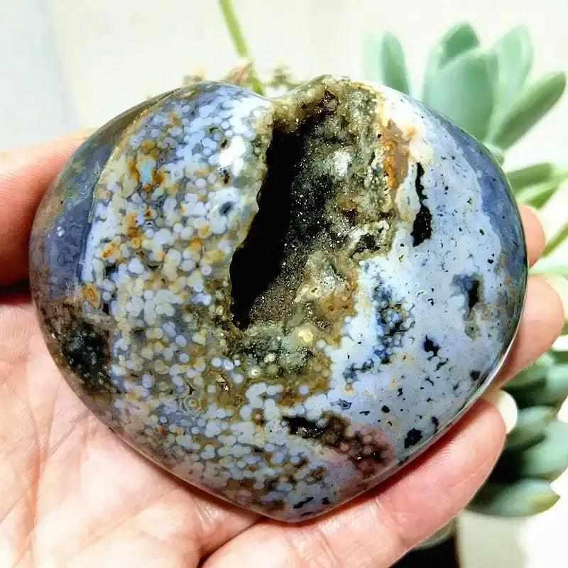 Polished Ocean Jasper heart featuring sea green and cream orb patterns with a natural crystal druzy center for calm energy.