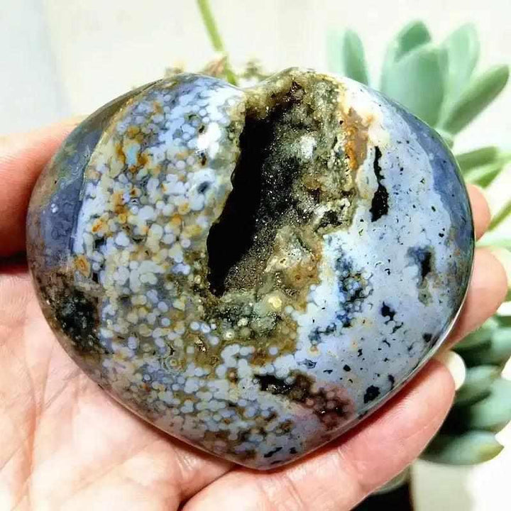 Polished Ocean Jasper heart featuring sea green and cream orb patterns with a natural crystal druzy center for calm energy.