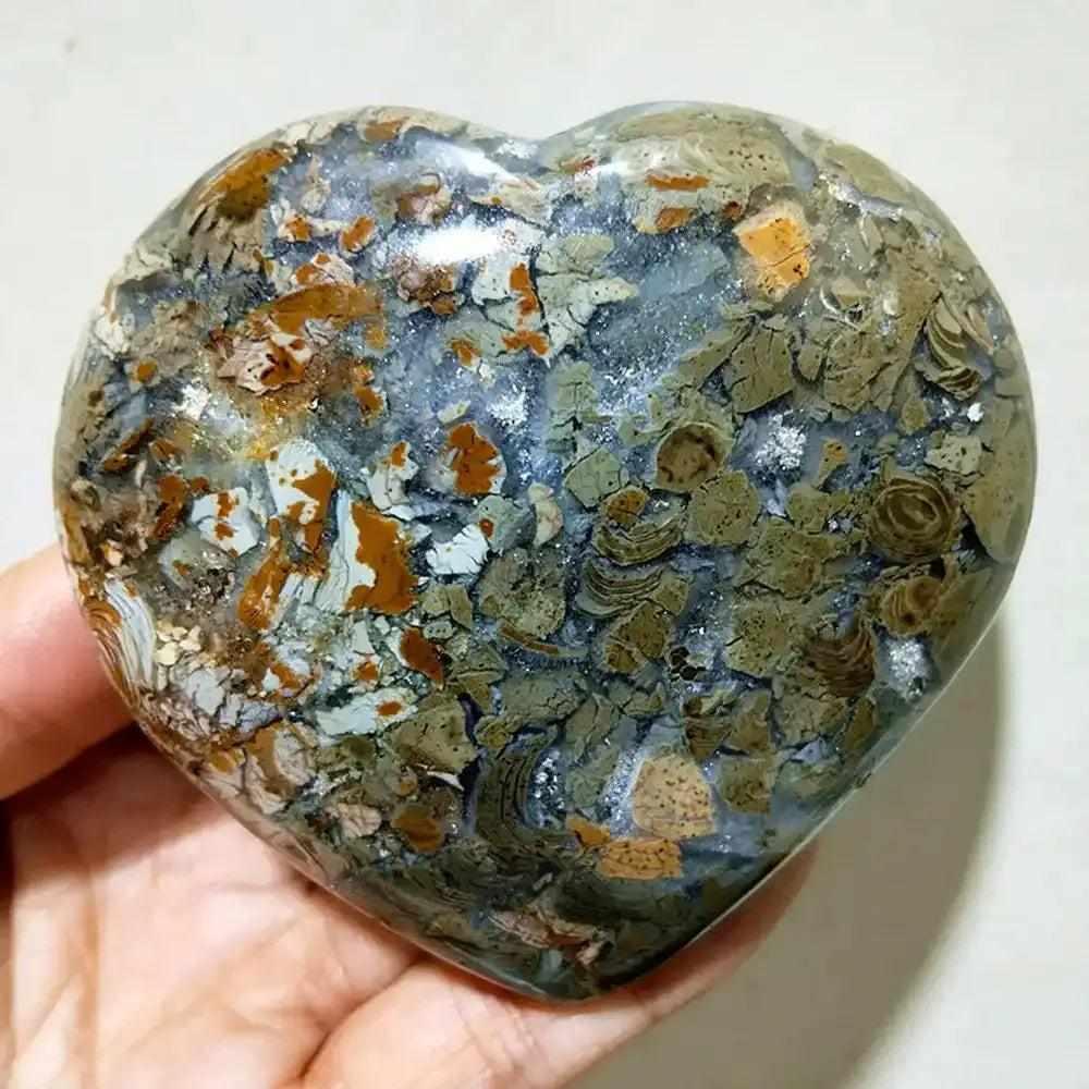 Polished Ocean Jasper heart stone featuring swirling green, white, and pink orbs for Heart Chakra healing and tranquility.