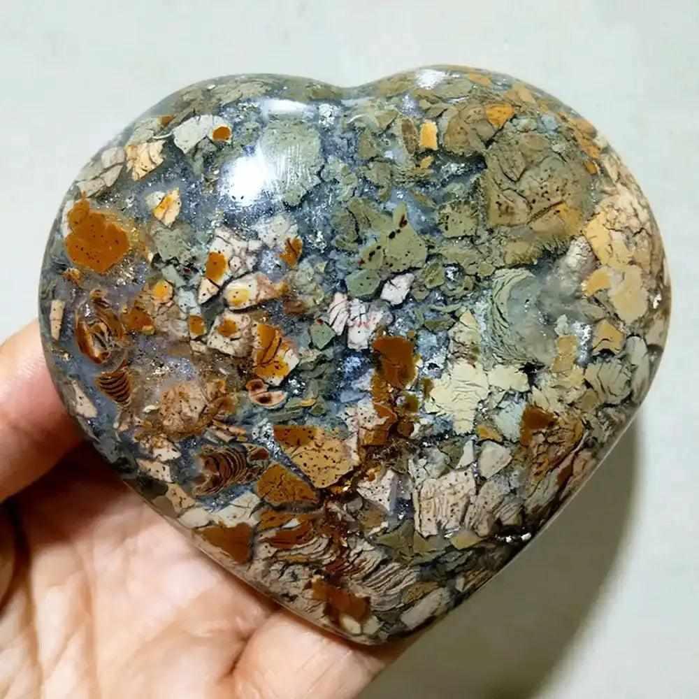 Polished Ocean Jasper heart stone featuring swirling green, white, and brown orb patterns for Heart Chakra healing.