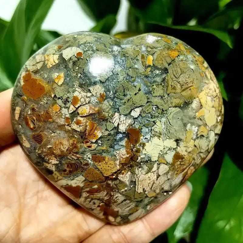 Polished Ocean Jasper heart stone featuring swirling green, white, and pink orbs for Heart Chakra healing and tranquility.