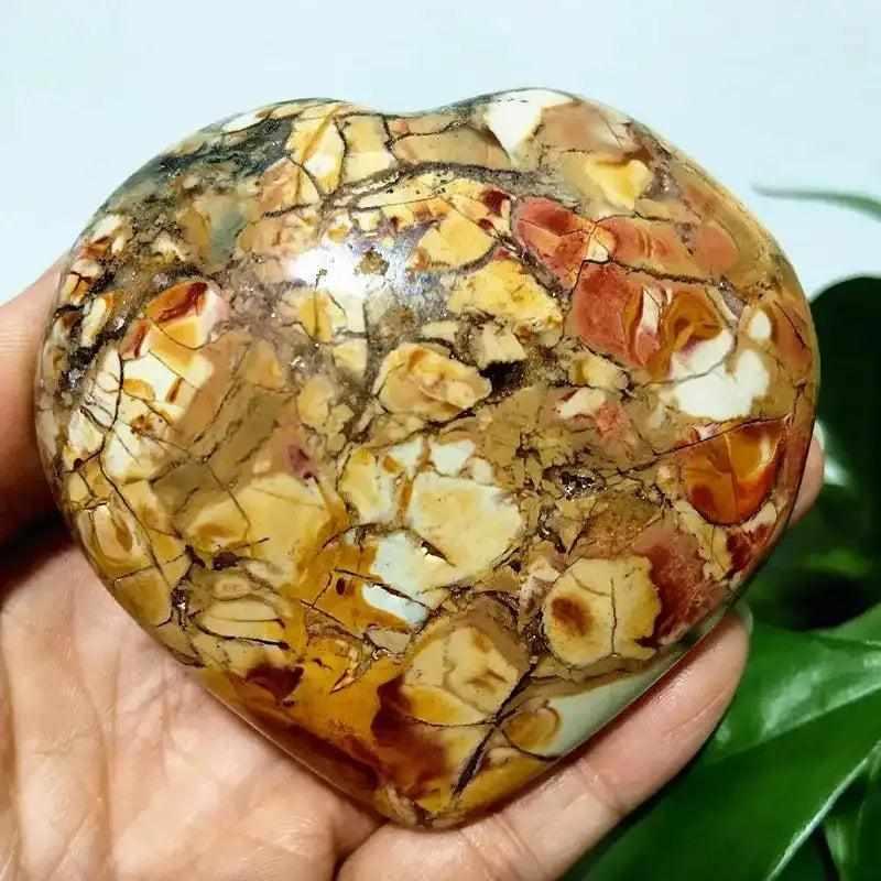 Polished Ocean Jasper heart stone featuring swirling green, pink, and cream orb patterns for Heart Chakra healing.