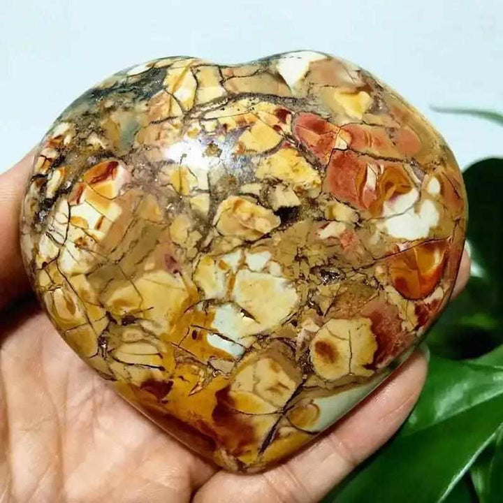 Polished Ocean Jasper heart stone featuring swirling green, pink, and cream orb patterns for Heart Chakra healing.