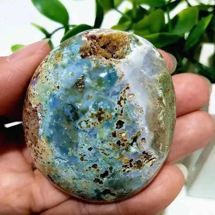 Polished Ocean Jasper palm stone with green and cream orbs, perfect for Heart Chakra healing and calming meditation.