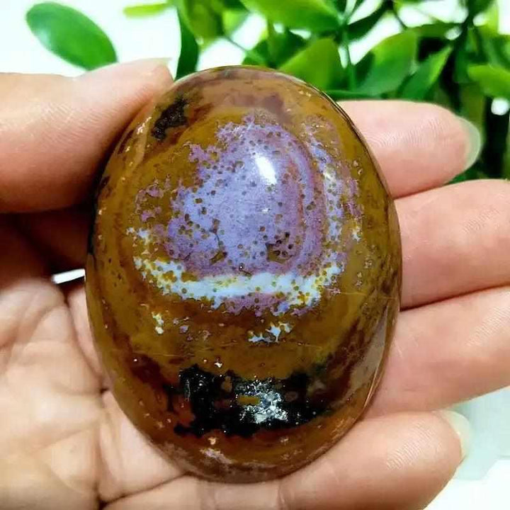 Polished Ocean Jasper palm stone with swirling green, cream, and pink orbs for Heart Chakra healing and calming energy.