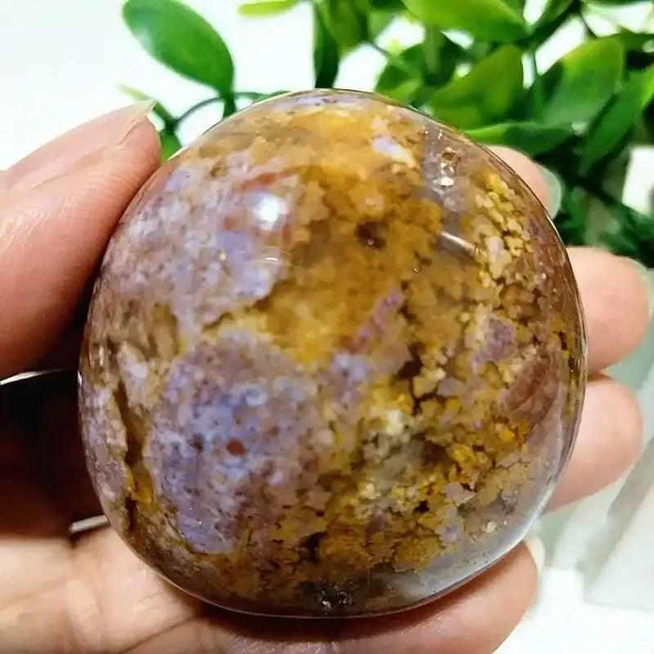 Polished Ocean Jasper palm stone featuring soothing green, cream, and pink orbs for Heart and Throat Chakra healing.