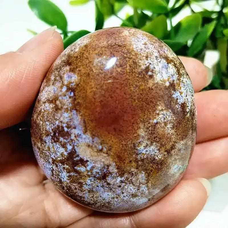 Polished Ocean Jasper palm stone with soothing green, cream, and pink swirls, perfect for Heart Chakra healing and calm.