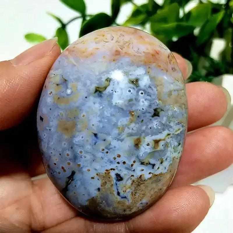 Smooth Ocean Jasper palm stone with calming green, cream, and pink orbs, perfect for Heart Chakra healing and relaxation.