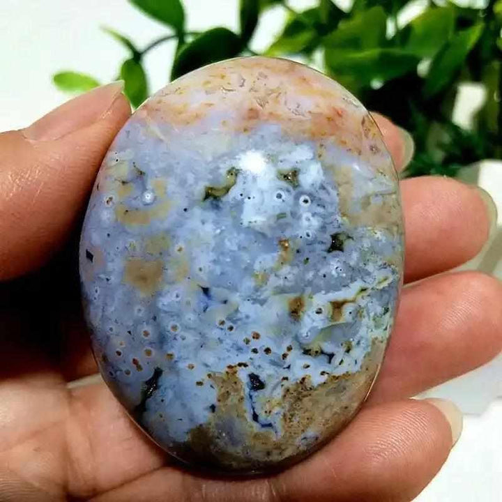 Smooth Ocean Jasper palm stone with calming green, cream, and pink orbs, perfect for Heart Chakra healing and relaxation.