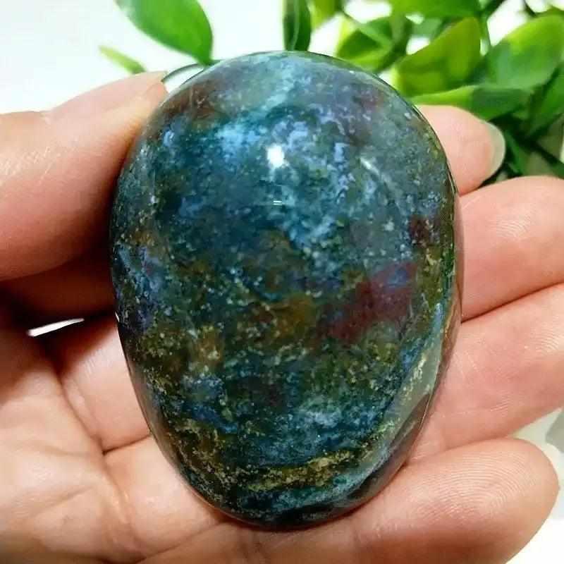 Polished Ocean Jasper palm stone with green and cream swirls, perfect for Heart Chakra healing and calming meditation.
