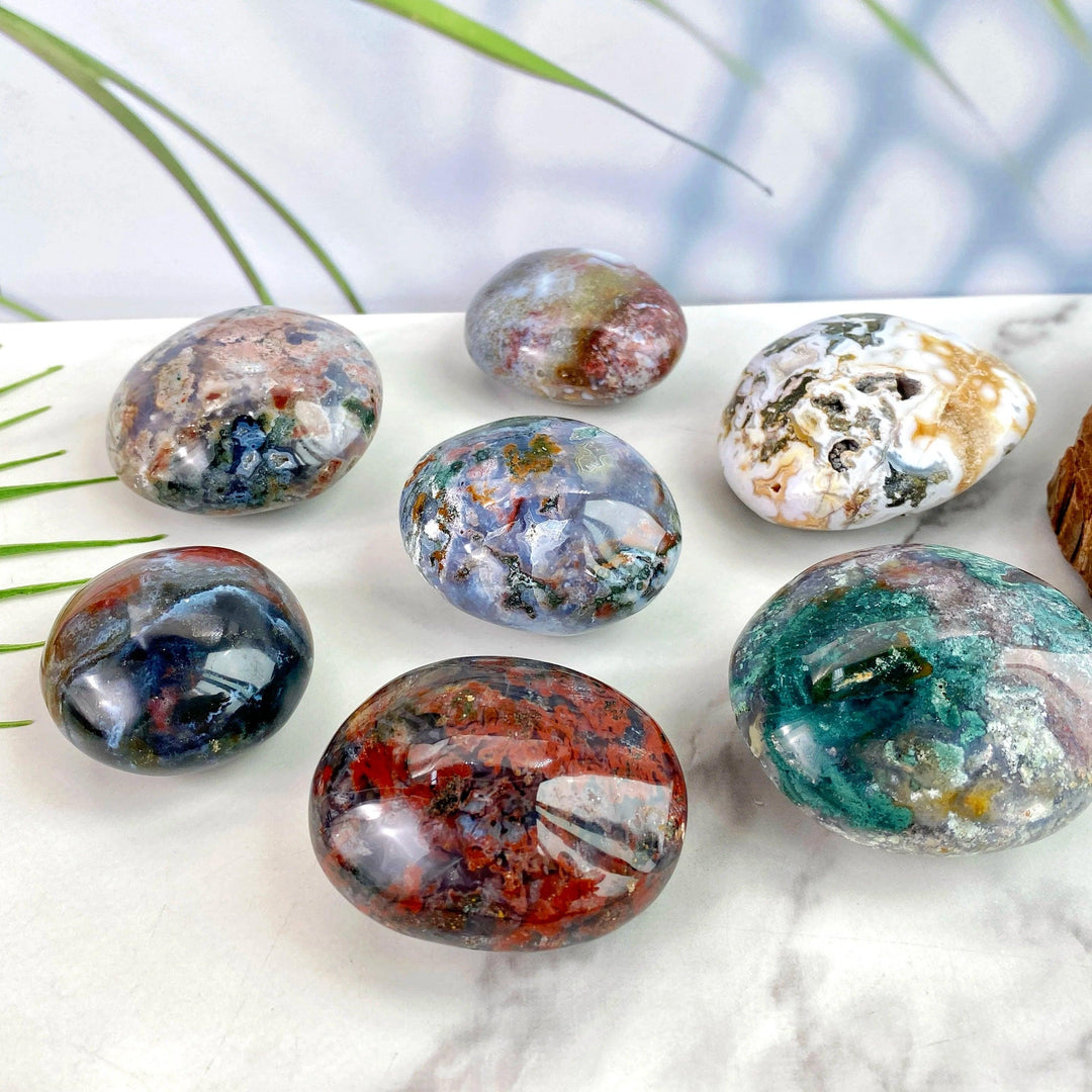 Polished Ocean Jasper palm stones featuring vibrant natural colors and unique patterns for healing and home decor.