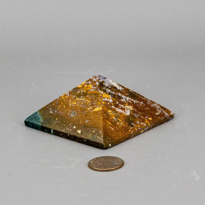 Crystal Destiny's 3" Ocean Jasper pyramid with earthy tones, orb patterns, and a quarter for scale.
