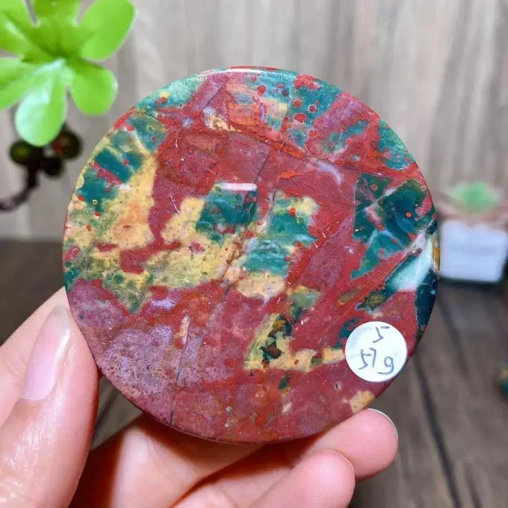 Polished round Bloodstone slice from Crystal Destiny, featuring vibrant red, green, and yellow patterns.