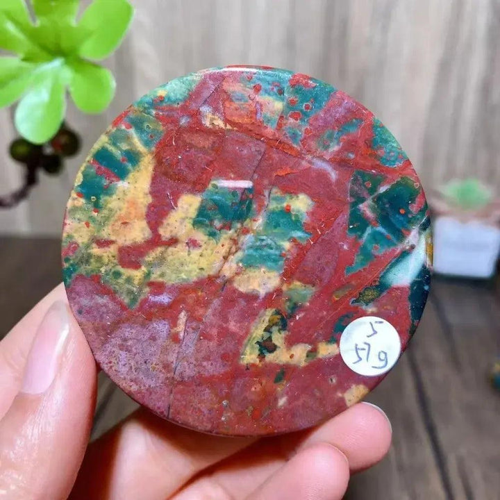 Polished round Bloodstone slice from Crystal Destiny, featuring vibrant red, green, and yellow patterns.