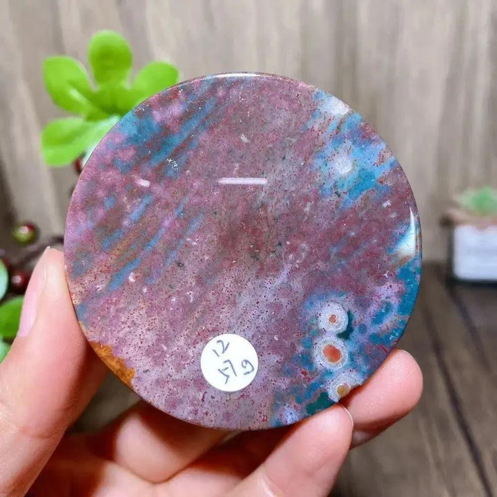 Polished Ocean Jasper round slice from Crystal Destiny, featuring vibrant pink, blue, and green patterns.