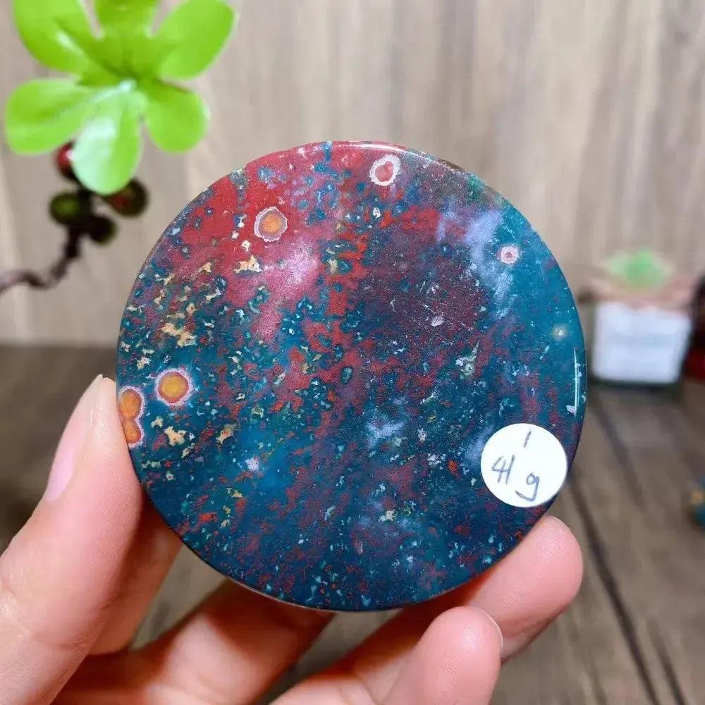 Crystal Destiny's Bloodstone round slice, featuring vibrant red, green, and yellow hues, ideal for healing.