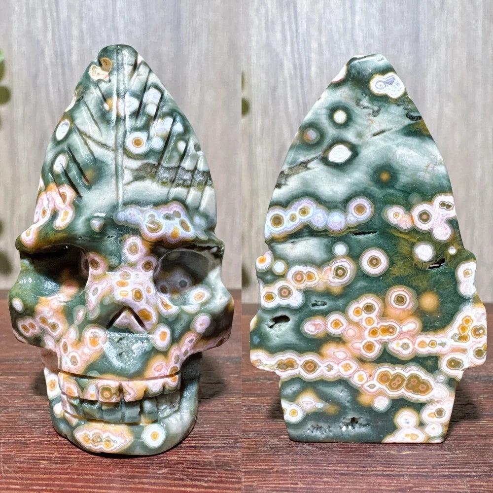 Hand-carved ocean jasper skull with green, pink, and orange orb patterns, ideal for healing and decor.