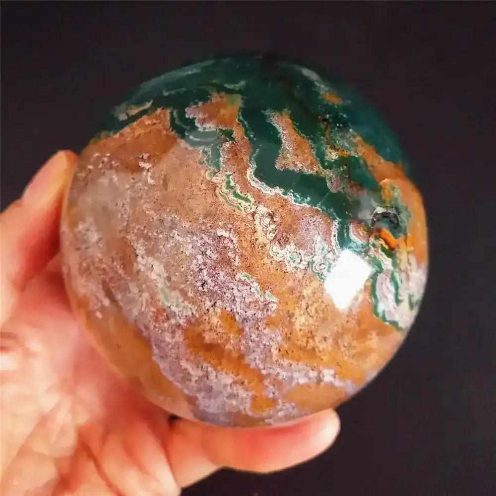 Polished Ocean Jasper sphere featuring soothing sea green, cream, and pink orb patterns for heart chakra healing.