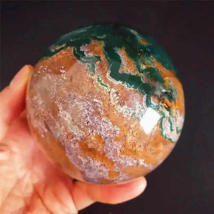 Polished Ocean Jasper sphere featuring soothing sea green, cream, and pink orb patterns for heart chakra healing.