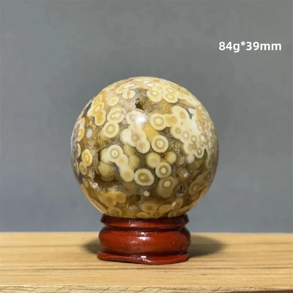 Ocean Jasper sphere from Crystal Destiny, 39mm, with unique cream, white, and yellow orbicular patterns on a red base.